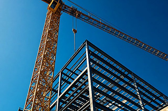 Tower crane over a steel building frame under construction