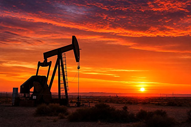 Oil pump jack silhouetted against a Texas sunset
